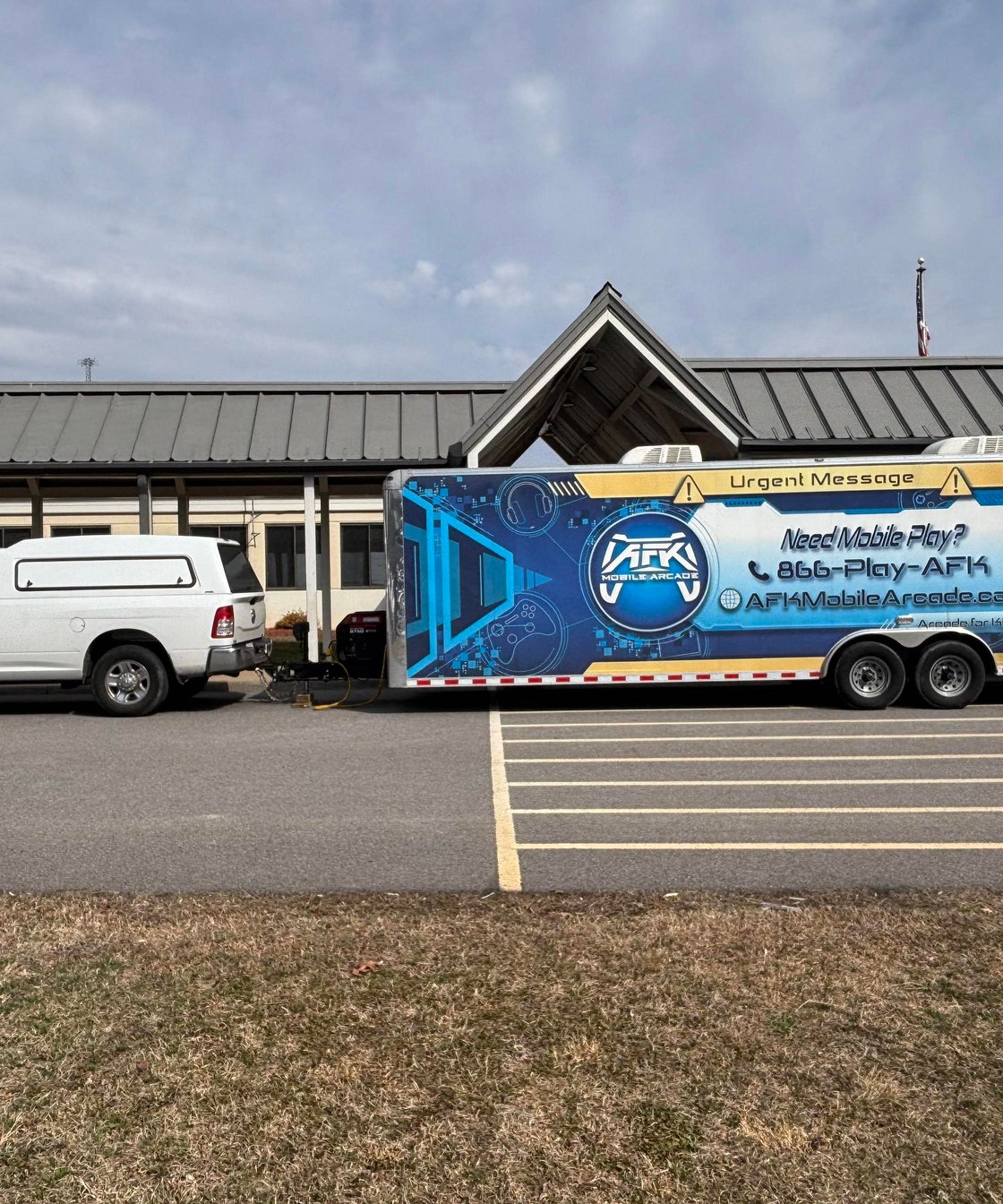 Mobile gaming arcade trailer parked outdoors at an event