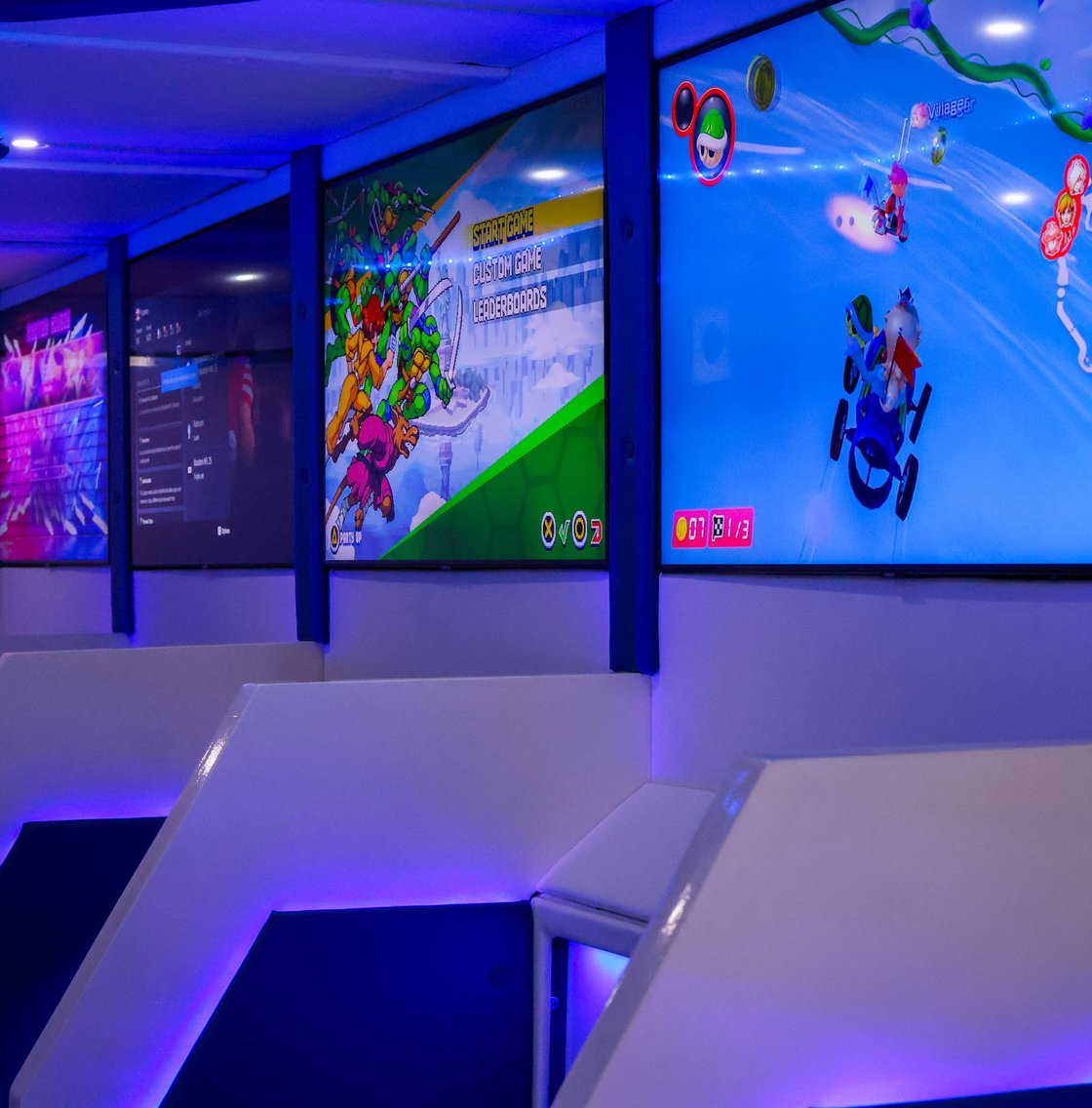 Gaming trailer interior with multiple lit video game screens