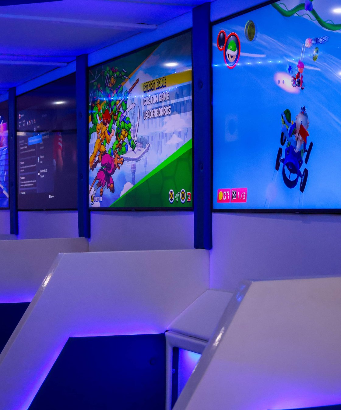 Gaming trailer interior with multiple lit video game screens