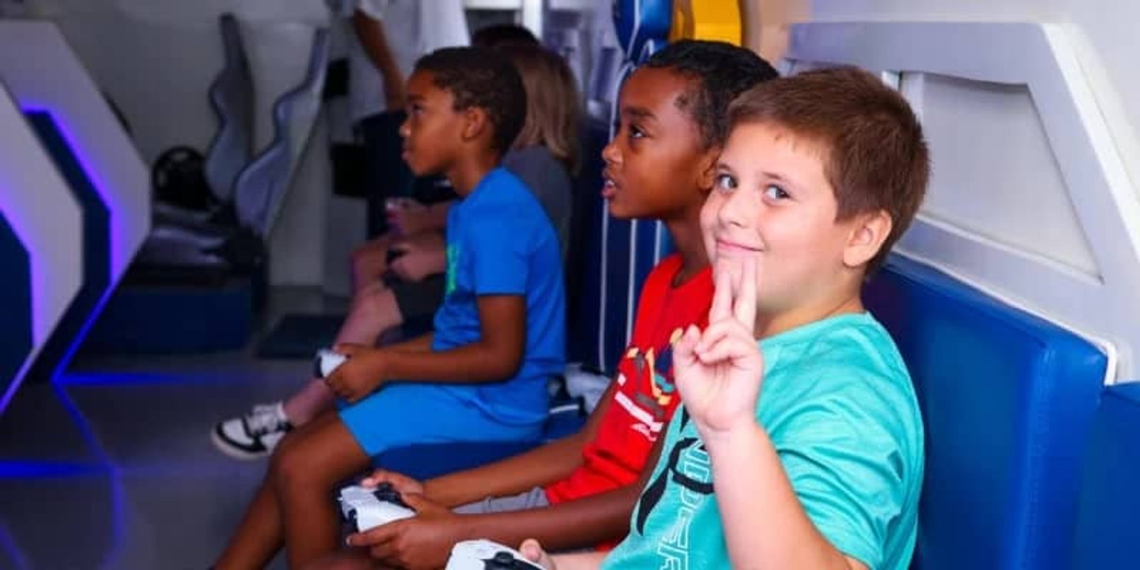 Kids playing together at a gaming birthday party in the mobile arcade trailer